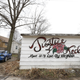 The side of a garage was tagged with a memorial for Kedarie Johnson in the alley where they were found dead March 2, 2016, in Burlington, Iowa. (Michael Zamora/Des Moines Register)